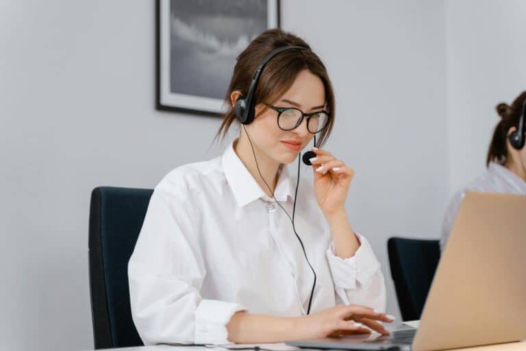 A woman wearing a headset doing a support