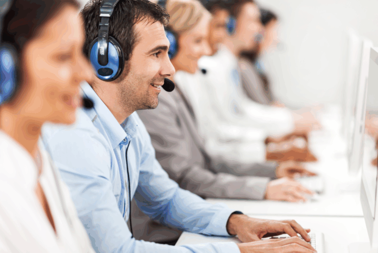 People wearing headsets talking infront of their computers